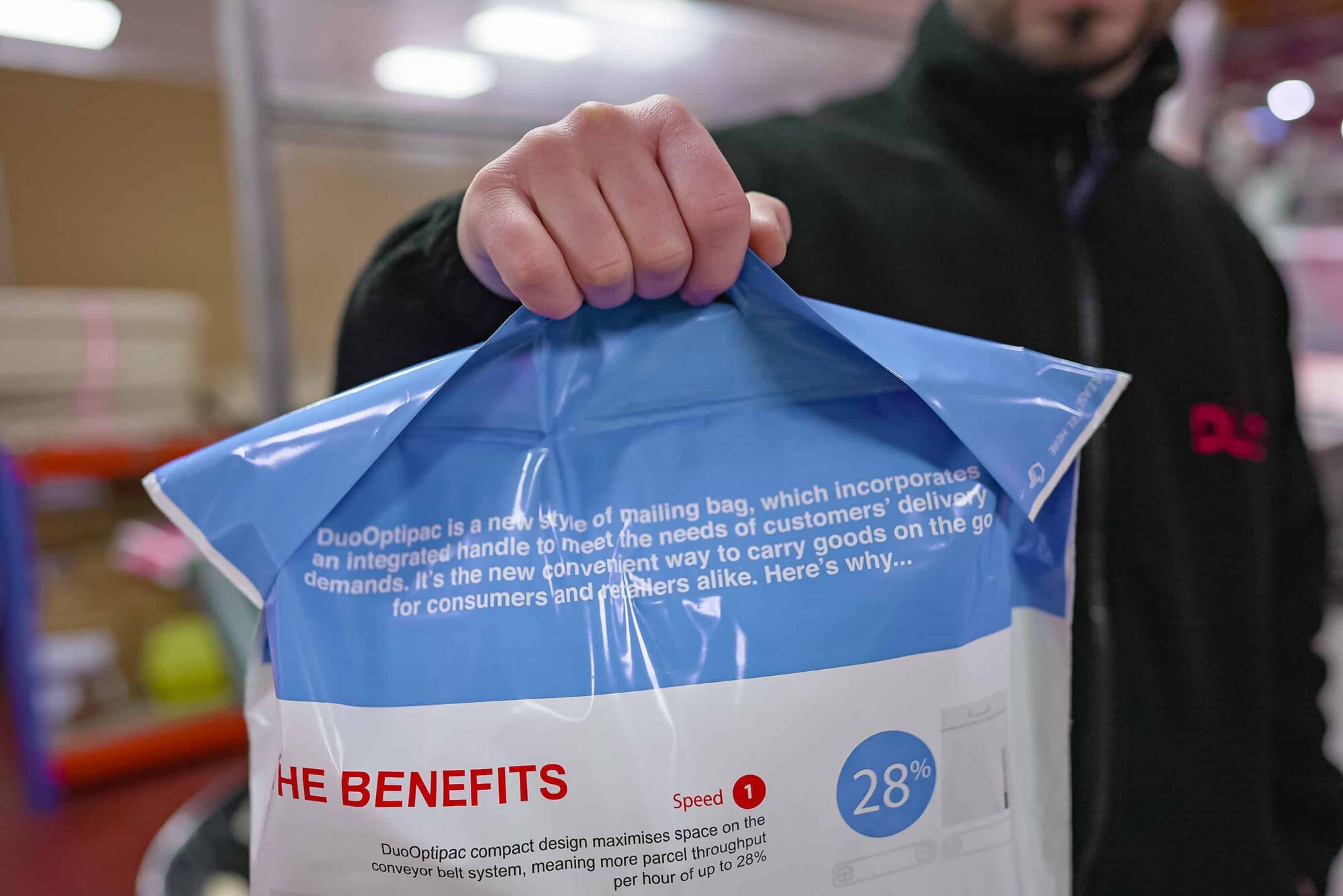 Duo Packaging Operative holding the handle of our Innovative packaging solution the DuoOptipac Mailing Bag.